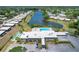 Aerial view of community pool, lake and clubhouse in a well-maintained community at 3816 Blue Stone Way # 97, Sarasota, FL 34232