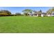 Extensive backyard featuring a lush lawn, mature trees, and well-kept landscaping at 3816 Blue Stone Way # 97, Sarasota, FL 34232