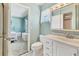 Well-lit bathroom featuring a white vanity, toilet, and partial view into an adjacent bedroom at 3816 Blue Stone Way # 97, Sarasota, FL 34232
