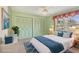Bright bedroom with a queen bed, colorful decor, large window, and dual closets for ample storage at 3816 Blue Stone Way # 97, Sarasota, FL 34232
