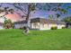 Low-rise exterior showcases well-manicured lawn and mature trees creating a serene and inviting curb appeal at 3816 Blue Stone Way # 97, Sarasota, FL 34232