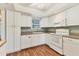 Well-lit kitchen featuring white cabinets, a tiled backsplash, and modern appliances at 3816 Blue Stone Way # 97, Sarasota, FL 34232