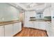 Bright kitchen featuring white cabinets, tiled backsplash, and modern appliances at 3816 Blue Stone Way # 97, Sarasota, FL 34232
