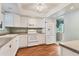 Bright kitchen featuring white cabinets, tiled backsplash, and modern appliances at 3816 Blue Stone Way # 97, Sarasota, FL 34232