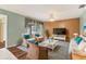 Cozy living room with ample seating, a ceiling fan, and large windows for natural light at 3816 Blue Stone Way # 97, Sarasota, FL 34232