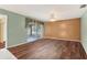 Spacious living room with luxury laminate flooring and a sliding door to the sunroom at 3816 Blue Stone Way # 97, Sarasota, FL 34232