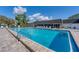 Community pool featuring clear blue water, ample lounge chairs, and well-maintained deck at 3816 Blue Stone Way # 97, Sarasota, FL 34232