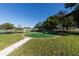 Putting green near a pond, perfect for leisurely outdoor activities in this active community at 3816 Blue Stone Way # 97, Sarasota, FL 34232