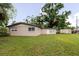Expansive backyard showcasing a well-maintained lawn, a charming shed, and mature trees providing ample shade at 4015 Asbury Pl, Sarasota, FL 34233