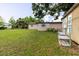 Lush backyard showing the home's exterior and a storage area, providing ample outdoor space at 4015 Asbury Pl, Sarasota, FL 34233