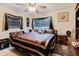 Bedroom features dark wood furniture, ceiling fan and decorative window coverings at 4015 Asbury Pl, Sarasota, FL 34233