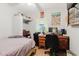 Cozy bedroom featuring a built-in closet, desk, and charming decorations that create a unique and inviting space at 4015 Asbury Pl, Sarasota, FL 34233
