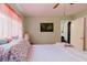 Light-green bedroom with wood floors, ceiling fan and a floral patterned bedspread at 4015 Asbury Pl, Sarasota, FL 34233