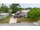Aerial view of the house featuring solar panels, a screened porch, landscaping, and a carport at 4015 Asbury Pl, Sarasota, FL 34233