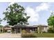 Charming single-story home featuring solar panels, a screened porch, and a covered carport at 4015 Asbury Pl, Sarasota, FL 34233