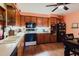 Tile countertop kitchen boasts wood cabinets and white tile backsplash at 4015 Asbury Pl, Sarasota, FL 34233