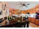 Eat-in kitchen features a large dining table, tile countertops and wood cabinets at 4015 Asbury Pl, Sarasota, FL 34233