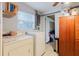 Functional laundry room featuring a washer, dryer, and storage solutions for efficient organization at 4015 Asbury Pl, Sarasota, FL 34233