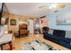 Comfortable living room featuring laminate flooring, a ceiling fan, and an open floor plan at 4015 Asbury Pl, Sarasota, FL 34233