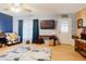 Cozy living room featuring laminate flooring, modern decor, and a ceiling fan at 4015 Asbury Pl, Sarasota, FL 34233