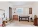 Bright room features neutral walls, a window, and an array of tables and decor; perfect for a versatile living space at 4015 Asbury Pl, Sarasota, FL 34233