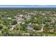 A neighborhood aerial view shows mature trees, beautiful surroundings and community features at 4251 Austin St, Sarasota, FL 34233