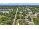 Expansive aerial view shows lush landscaping, mature trees and the neighborhood's beautiful surroundings at 4251 Austin St, Sarasota, FL 34233