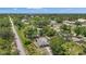 Aerial view showcases the property nestled among lush trees, near a neighborhood, and scenic surroundings at 4251 Austin St, Sarasota, FL 34233