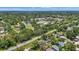 The aerial view showcases the neighborhood with mature trees, and houses along the street at 4251 Austin St, Sarasota, FL 34233