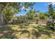 Large backyard with a fire pit and mature trees, perfect for outdoor gatherings and recreation at 4251 Austin St, Sarasota, FL 34233