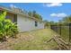 Side yard featuring a privacy fence and lush greenery, creating a private and tranquil outdoor space at 4251 Austin St, Sarasota, FL 34233