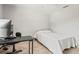 Carpeted bedroom featuring a small bed, work desk, and ceiling fan at 4251 Austin St, Sarasota, FL 34233