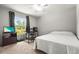 Bedroom with a ceiling fan, single bed, and a window providing natural light at 4251 Austin St, Sarasota, FL 34233