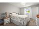 Serene bedroom with a floral patterned bedspread, soft lighting, and a peaceful ambiance at 4251 Austin St, Sarasota, FL 34233