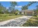 Charming one-story house with a well-maintained lawn and long driveway leading to an attached one car garage at 4251 Austin St, Sarasota, FL 34233
