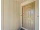 Close-up of the front door with a modern door handle and a neutral color scheme, enhanced by natural lighting at 4251 Austin St, Sarasota, FL 34233