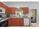 Efficient kitchen layout featuring ample counter space, wood cabinets, and a view to the lanai at 4251 Austin St, Sarasota, FL 34233