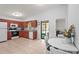 Bright kitchen boasts wood cabinets, white appliances, and an eat-in area with access to the lanai at 4251 Austin St, Sarasota, FL 34233
