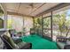 Screened lanai featuring comfortable seating and a ceiling fan at 4251 Austin St, Sarasota, FL 34233