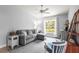 Bright living room featuring neutral walls, a comfortable couch, and a large window overlooking a wooded area at 4251 Austin St, Sarasota, FL 34233