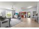 Open-concept living area with tile floors, a ceiling fan, and abundant natural light from a large window at 4251 Austin St, Sarasota, FL 34233