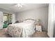 Cozy carpeted main bedroom featuring a queen bed and sliding doors to the screened lanai at 4251 Austin St, Sarasota, FL 34233