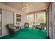 Inviting sunroom featuring comfortable wicker seating and a ceiling fan, ideal for leisurely afternoons at 4251 Austin St, Sarasota, FL 34233