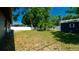Large fenced backyard with mature trees, lush green grass and a storage shed at 4310 7Th W Ave, Bradenton, FL 34209