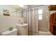 Clean, bright bathroom with a charming pineapple shower curtain and white tile at 4310 7Th W Ave, Bradenton, FL 34209
