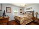 Comfortable bedroom with a rattan frame bed, charming decor, and dark wood floors at 4310 7Th W Ave, Bradenton, FL 34209