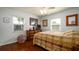 Cozy bedroom featuring warm wood floors and ample natural light from two windows at 4310 7Th W Ave, Bradenton, FL 34209