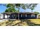 Charming single-story home features a blue facade, well-maintained lawn, and cozy front porch at 4310 7Th W Ave, Bradenton, FL 34209