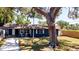 Charming single-story home features a blue facade, well-maintained lawn, and cozy front porch at 4310 7Th W Ave, Bradenton, FL 34209