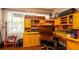 Bright home office with natural light, custom built-ins and a classic executive desk chair at 4310 7Th W Ave, Bradenton, FL 34209